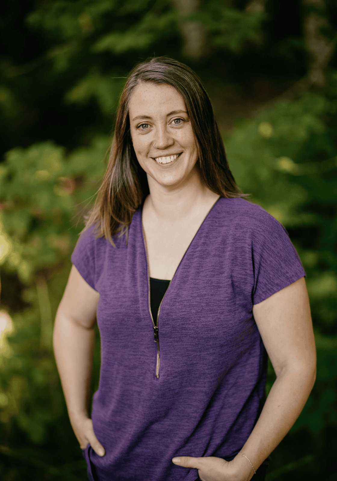 Molly Orear founder and lead teacher at hidden meadow forest school olympia washington portrait of her standing in front of forest