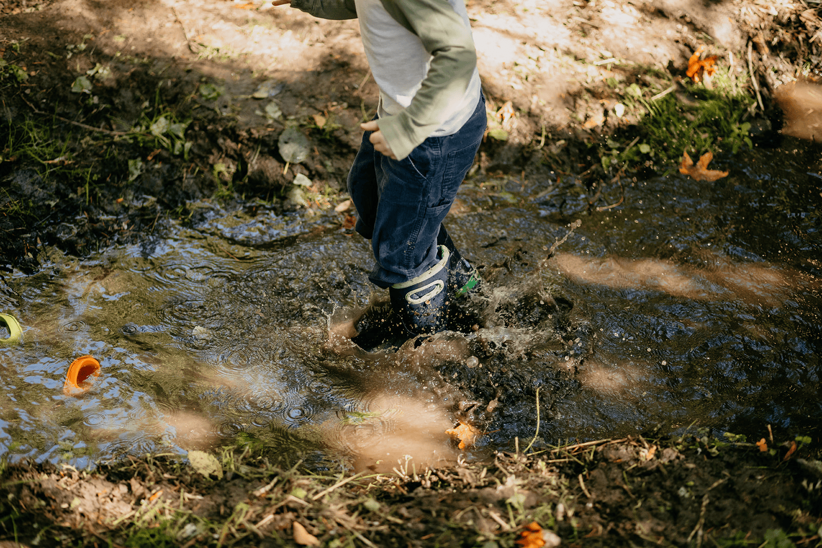 Hidden Meadow child jumping in Forest Creek