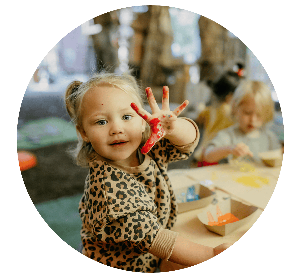Child holding up paint on their hand