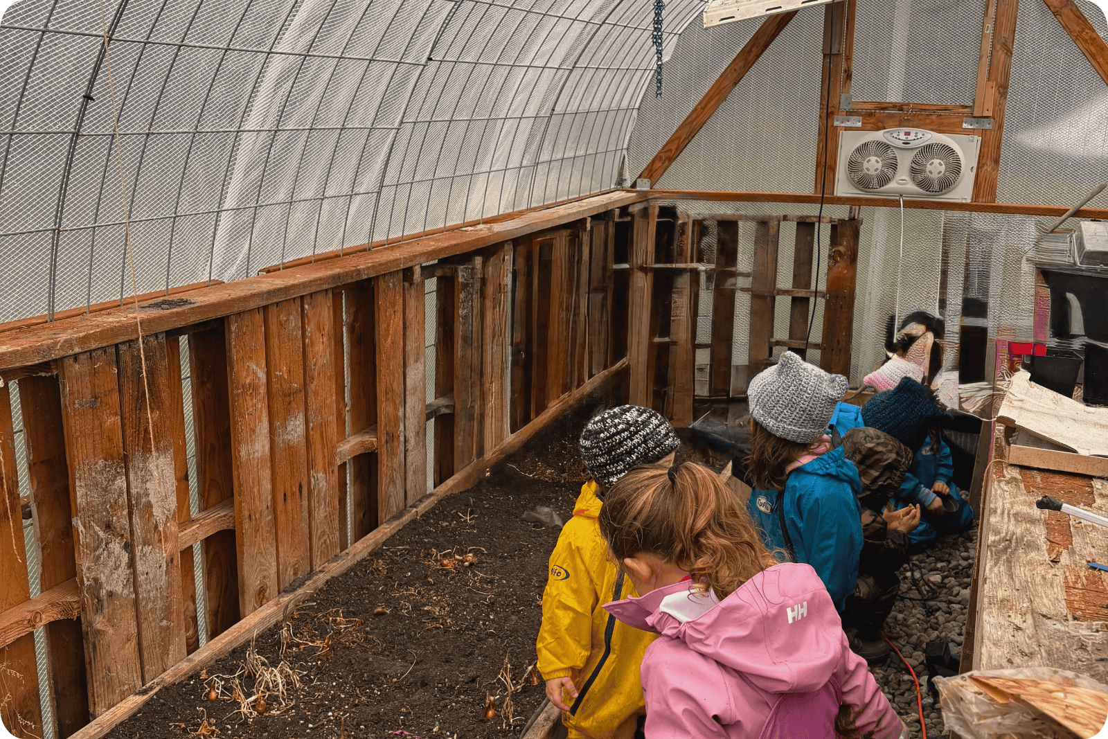 Hidden Meadow Greenhouse with children inside