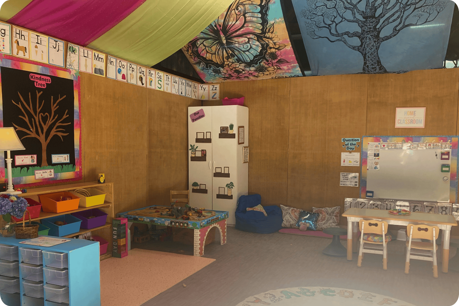Hidden Meadow Indoor Classroom space showing toy bins, kid table, walls and train table