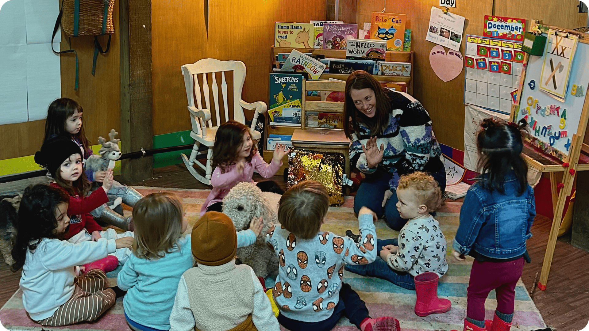 Molly teaching children inside indoor structure at Hidden Meadow School