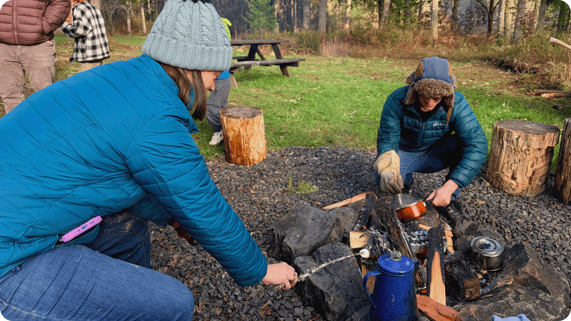 Hidden Meadow School Open Meadow Days Molly and Jake toasting marshmallows and heating hot cocoa over the fire