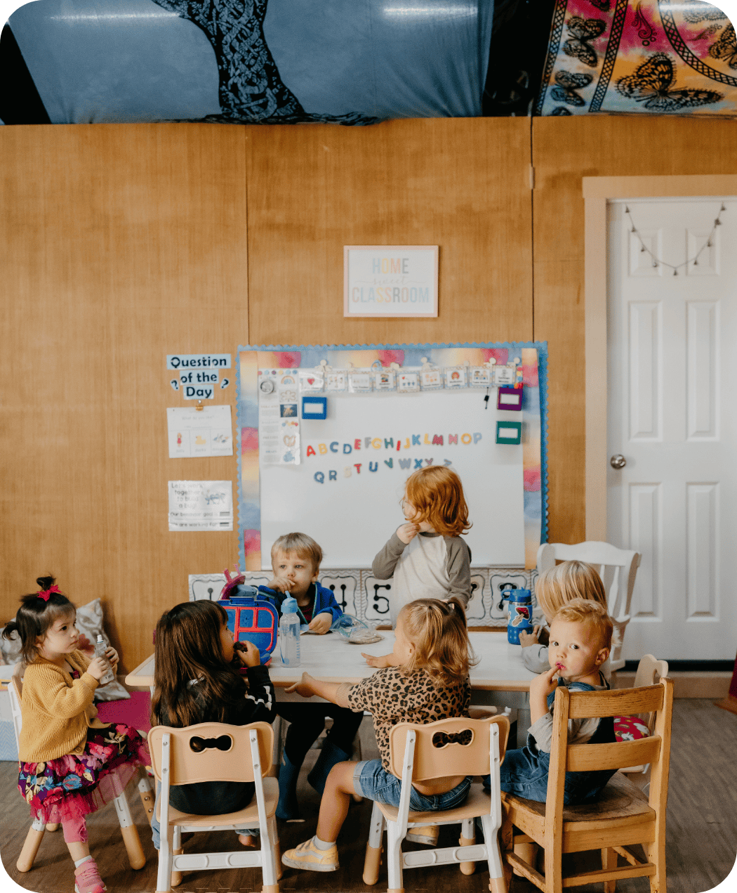 Children eating snack at table at Hidden Meadow School