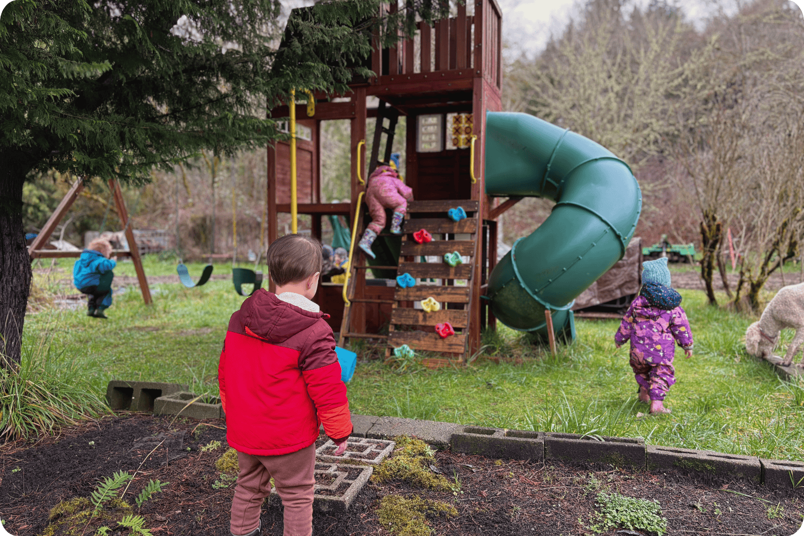 Hidden Meadow Playground with children playing on and around it