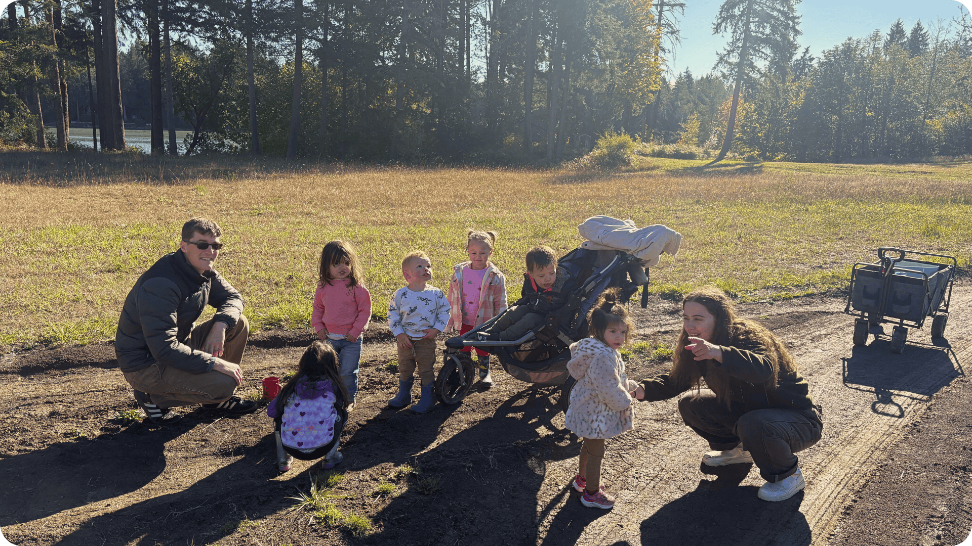 Jake kneeling on the path on The Meadow at Hidden Meadow School